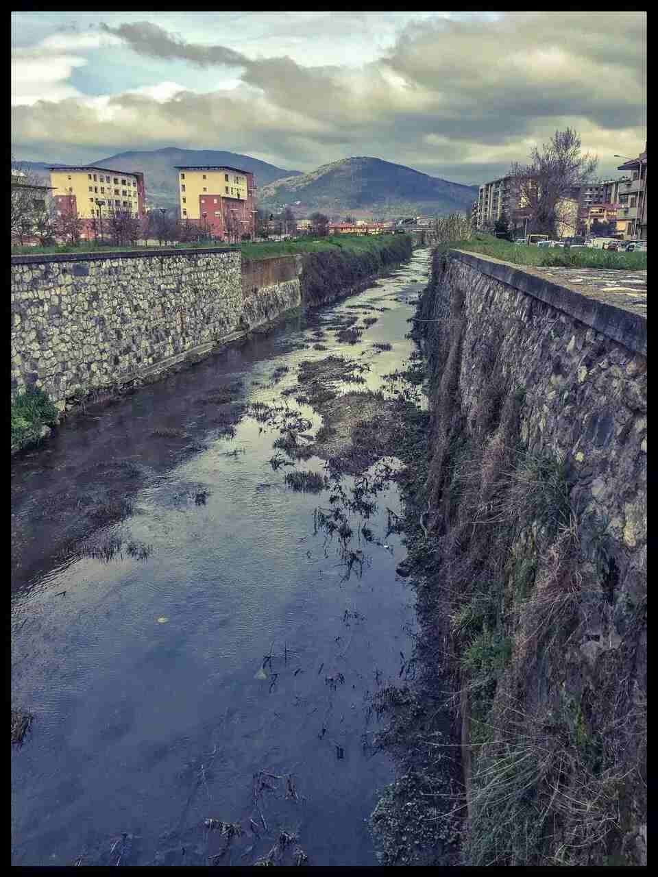 transfer print, auto post production filter, sky, architecture, built structure, water, building exterior, cloud - sky, the way forward, cloud, cloudy, diminishing perspective, river, outdoors, day, nature, incidental people, street, transportation, road