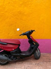 Side view of motor scooter on wall