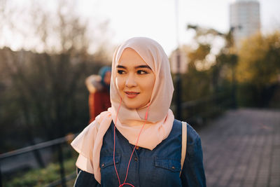 Portrait of smiling young woman standing outdoors