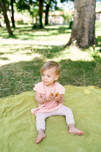 Portrait of cute girl sitting on grass