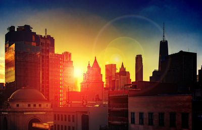 Buildings in city during sunset