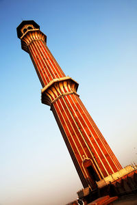 Low angle view of historic column against clear blue sky