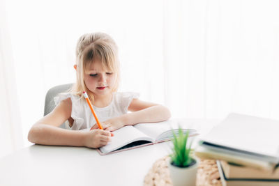 Young woman sitting on book