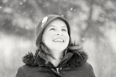 Portrait of smiling young woman in snow