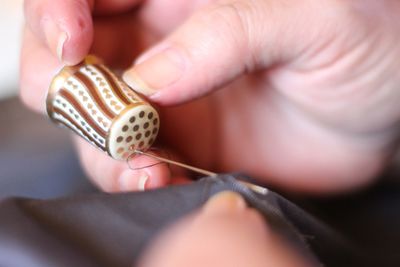 Close-up of woman stitching fabric