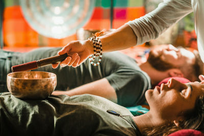 Therapist playing rin gong while performing music therapy at spa