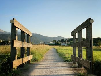 View of wooden built structure on landscape against clear sky