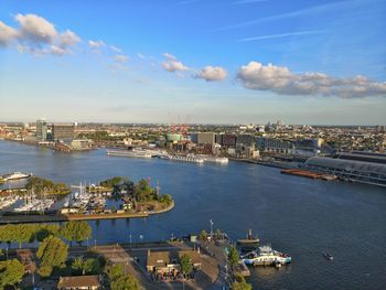 High angle view of cityscape by sea against sky