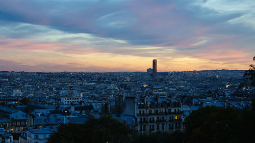 High angle view of buildings in city at sunset