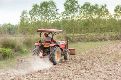 Man riding tractor on field