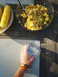 High angle view of hand holding food on table