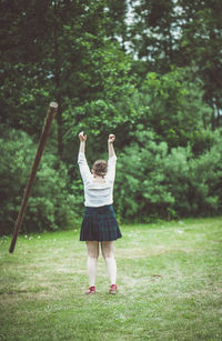 Rear view of woman on field