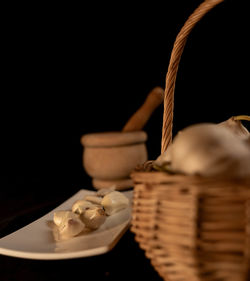 Close-up of wicker basket against black background