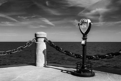 Serene scene with a coin operated  telescope at a usually crowded lake ontario lookout burlington