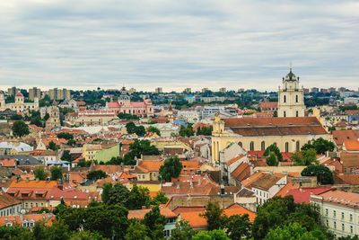 View of cityscape against cloudy sky