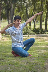Young man sitting on field