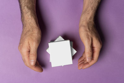 Cropped hand of woman holding paper