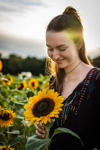 Beautiful young woman with sunflower