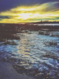 Scenic view of sea against cloudy sky