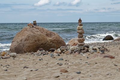 Scenic view of rocks on beach against sky