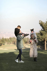 Rear view of man photographing with camera