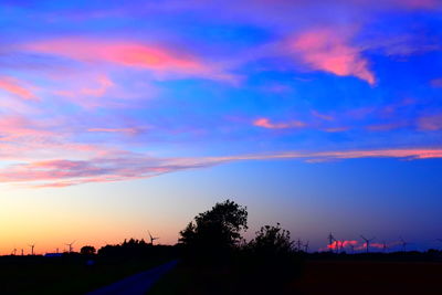 Silhouette trees against sky during sunset