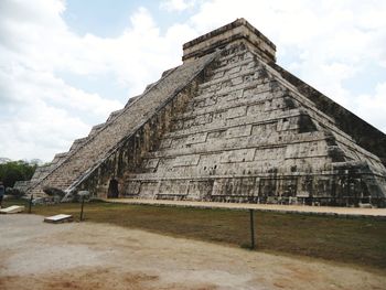 Low angle view of historical building against cloudy sky