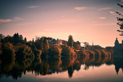 Scenic view of lake against sky at sunset