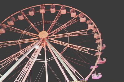 Low angle view of ferris wheel against sky at night