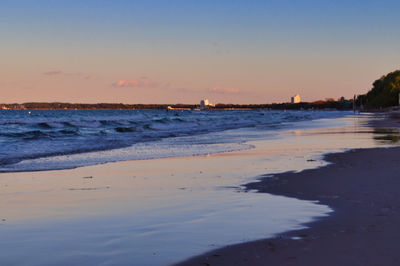 Scenic view of beach against sky during sunset