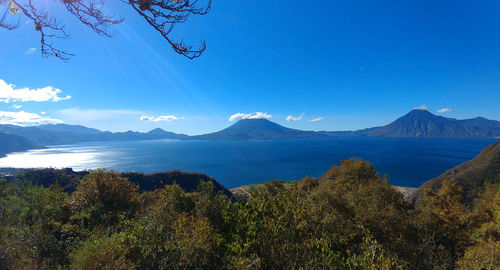 Scenic view of mountains against blue sky