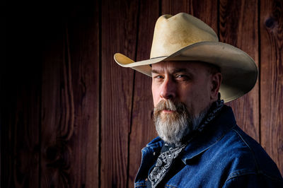 Older man with gray beard wearing a cowboy hat