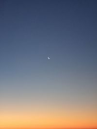 Low angle view of moon against clear sky at night