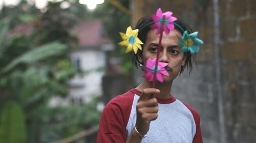 Serious man holding pinwheel toy