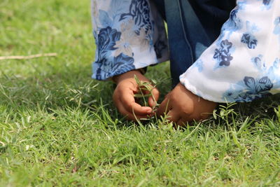 Low section of woman on field