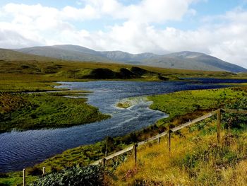 Scenic view of landscape against cloudy sky