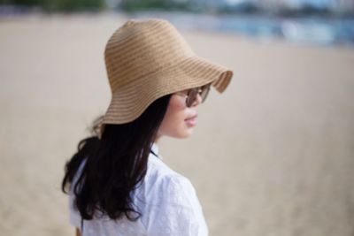Woman wearing hat at beach