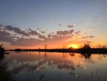 Scenic view of lake against sky during sunset