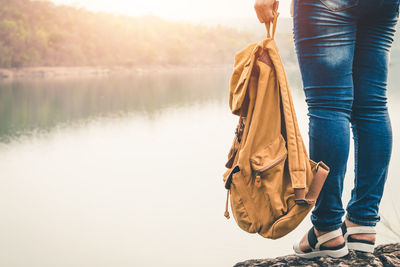 Low section of women walking on lake