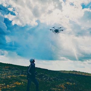 Low angle view of helicopter flying against sky