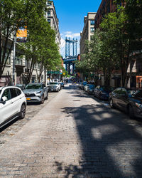 Cars on street by buildings in city