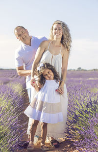 Beautiful young family on purple flower lavender field. family vacation
