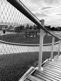 View of bridge through chainlink fence