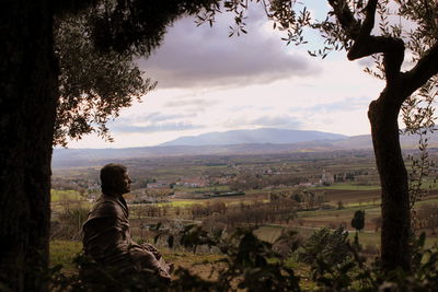 Scenic view of landscape against cloudy sky