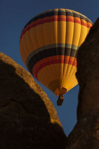 Low angle view of hot air balloon flying against sky