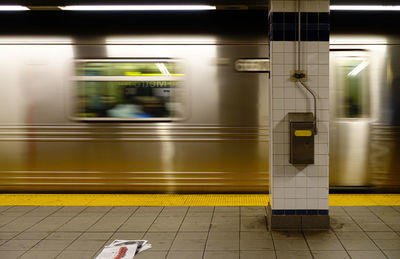 Blurred motion of train at railroad station