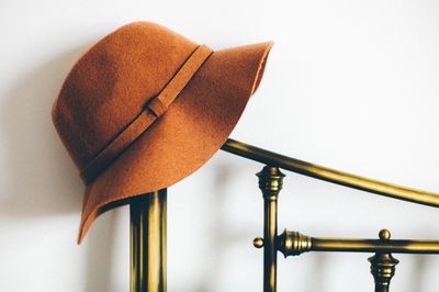 Hat on stand against white wall