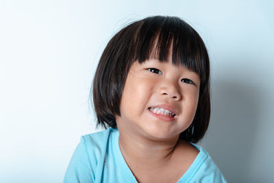 Portrait of smiling boy against white background