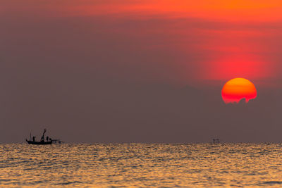 Scenic view of sea against orange sky