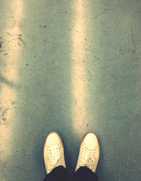 Low section of person standing on wet floor